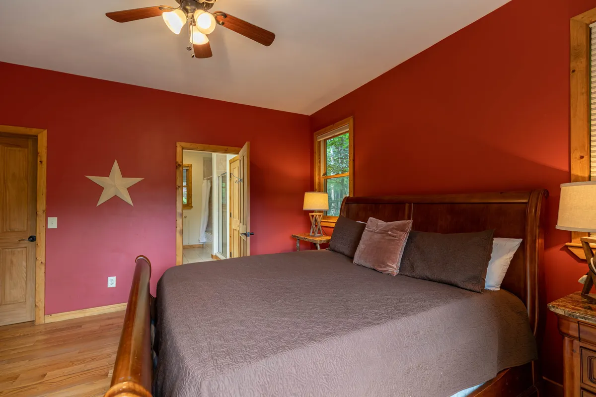 This interior image showcases a cozy bedroom with a bed positioned to enjoy natural light from a nearby window. A star decoration adds a whimsical touch while the overall scene feels warm and inviting, ideal for restful moments or quiet conversations.